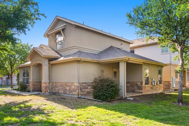 exterior space with stucco siding, stone siding, and a lawn