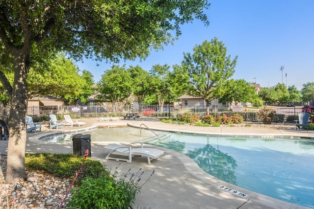 pool with fence and a patio