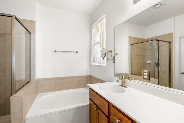 full bath with a shower stall, a garden tub, and vanity