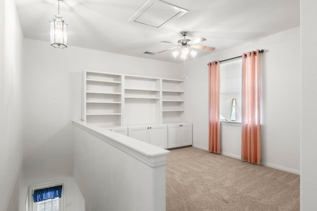 interior space featuring light carpet, a ceiling fan, and visible vents
