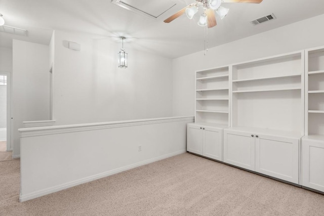 unfurnished room with baseboards, a ceiling fan, visible vents, and light colored carpet