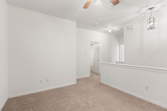 carpeted spare room with baseboards and ceiling fan