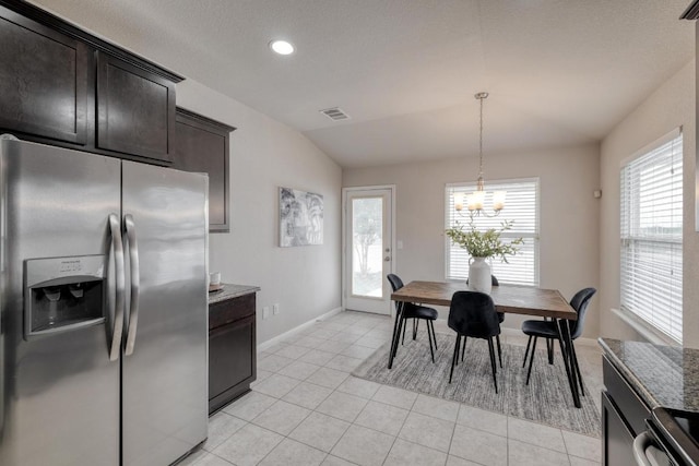 dining space featuring baseboards, a healthy amount of sunlight, visible vents, and light tile patterned floors