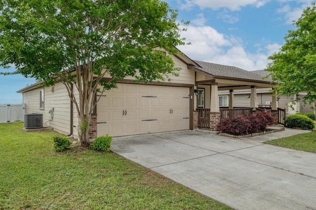 view of front of home with central AC, a garage, driveway, a front yard, and roof with shingles