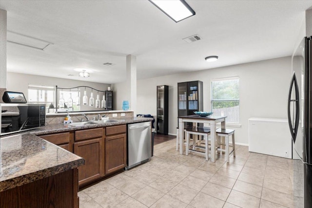 13625 Coomer Path, Pflugerville, TX 78660 - kitchen with appliances with stainless steel finishes, a sink, healthy amount of natural light, and light tile patterned floors