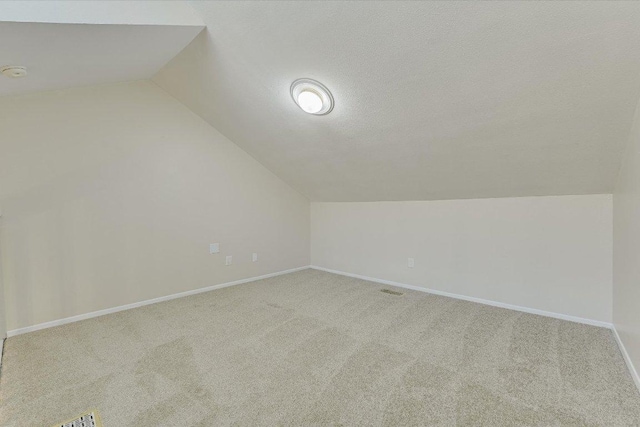 2815 Rio Grande St Unit 211, Austin, TX 78705 - additional living space with lofted ceiling, carpet floors, and a textured ceiling