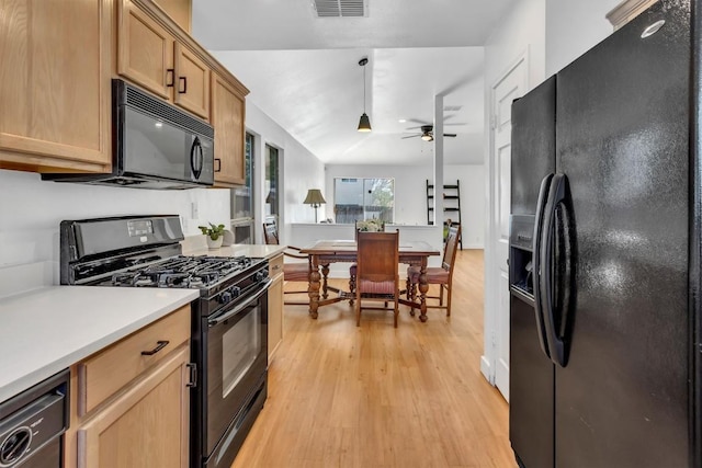 kitchen with light countertops, visible vents, a ceiling fan, black appliances, and light wood-style flooring