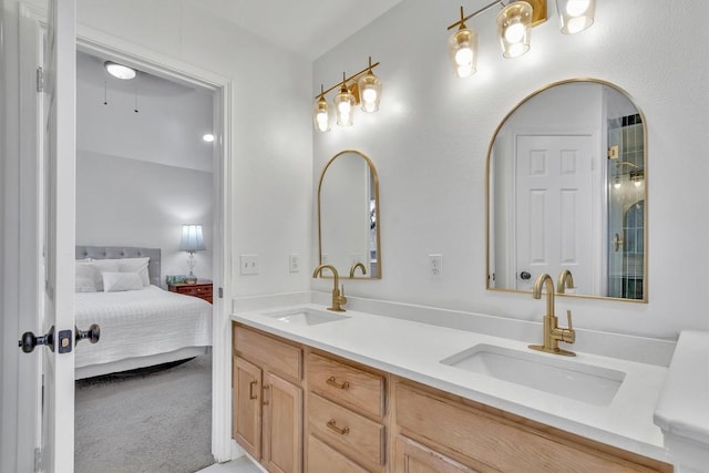 full bathroom featuring double vanity, ensuite bath, and a sink