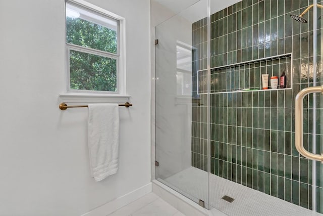 bathroom featuring baseboards and a stall shower
