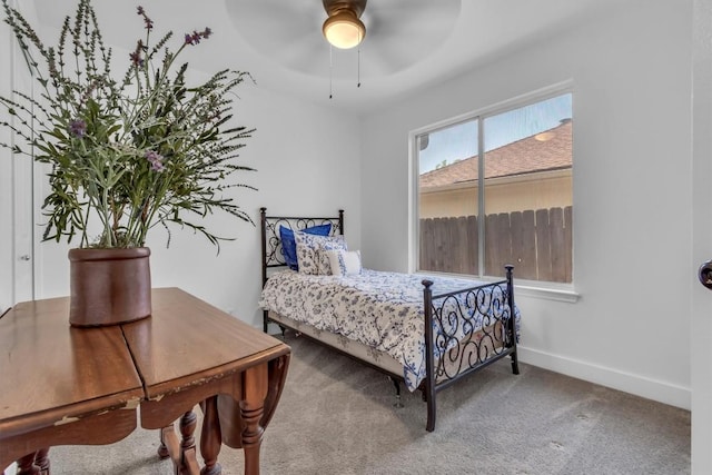 bedroom featuring carpet floors, a ceiling fan, and baseboards