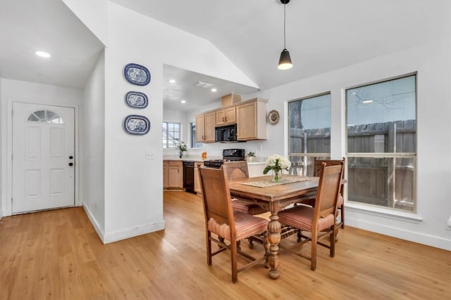 dining space featuring recessed lighting, lofted ceiling, light wood-style flooring, and baseboards