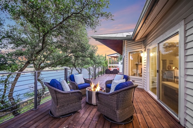 22401 Felicia Dr, Spicewood, TX 78669 - deck at dusk featuring an outdoor living space with a fire pit