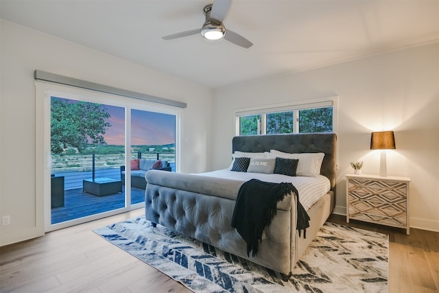 bedroom featuring ceiling fan, wood finished floors, baseboards, and access to outside