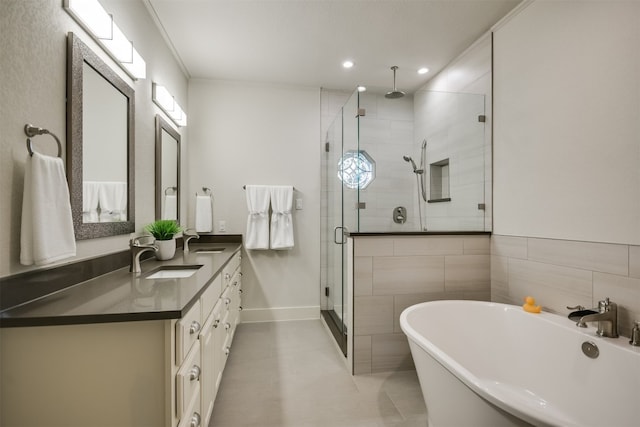 22401 Felicia Dr, Spicewood, TX 78669 - full bathroom with a shower stall, double vanity, a soaking tub, tile patterned floors, and recessed lighting