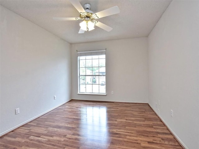 8411 Glen Canyon Dr, Round Rock, TX 78681 - unfurnished room featuring wood finished floors, ceiling fan, baseboards, and a textured ceiling