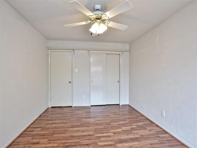 8411 Glen Canyon Dr, Round Rock, TX 78681 - unfurnished bedroom featuring wood finished floors, a textured ceiling, a closet, and ceiling fan