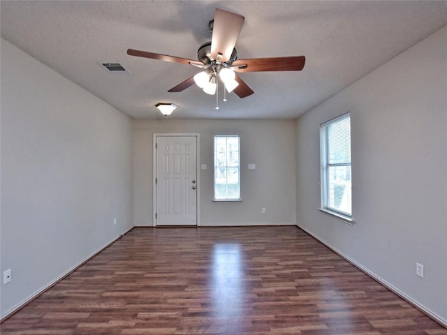 8411 Glen Canyon Dr, Round Rock, TX 78681 - empty room featuring a ceiling fan, healthy amount of natural light, wood finished floors, and a textured ceiling