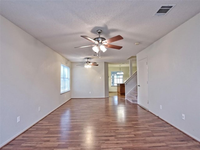 8411 Glen Canyon Dr, Round Rock, TX 78681 - spare room featuring a ceiling fan, wood finished floors, stairway, a textured ceiling, and baseboards