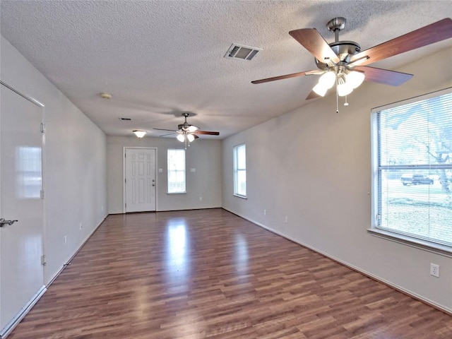8411 Glen Canyon Dr, Round Rock, TX 78681 - empty room featuring a ceiling fan, wood finished floors, a textured ceiling, and baseboards