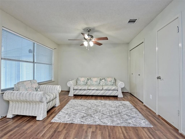 8411 Glen Canyon Dr, Round Rock, TX 78681 - living area featuring ceiling fan, wood finished floors, and a textured ceiling
