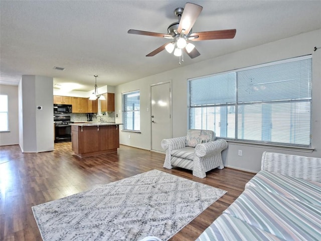 8411 Glen Canyon Dr, Round Rock, TX 78681 - living area with a ceiling fan, baseboards, and dark wood-type flooring