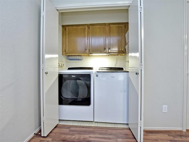 8411 Glen Canyon Dr, Round Rock, TX 78681 - laundry area featuring washing machine and clothes dryer, cabinet space, light wood-type flooring, and baseboards