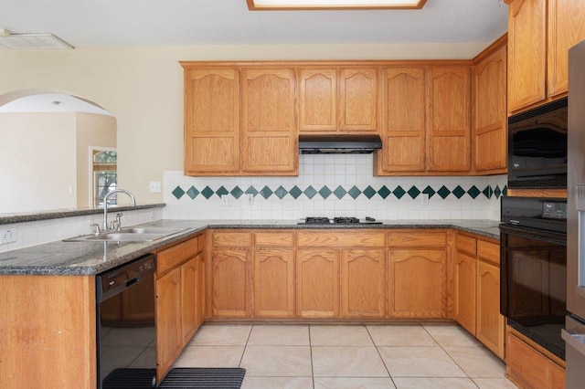 13321 Kirkglen Dr, Austin, TX 78727 - kitchen with black appliances, a sink, a peninsula, arched walkways, and light tile patterned floors