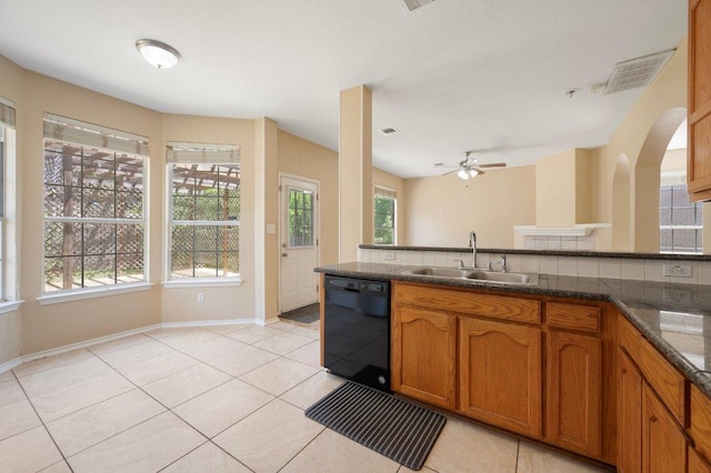 13321 Kirkglen Dr, Austin, TX 78727 - kitchen featuring black dishwasher, a sink, brown cabinetry, and plenty of natural light
