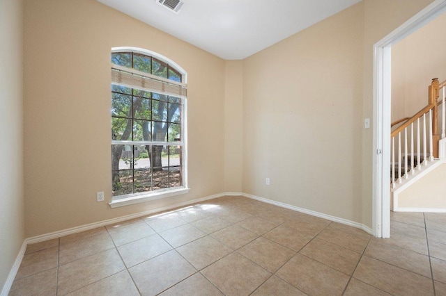 13321 Kirkglen Dr, Austin, TX 78727 - empty room featuring light tile patterned flooring, baseboards, and stairway