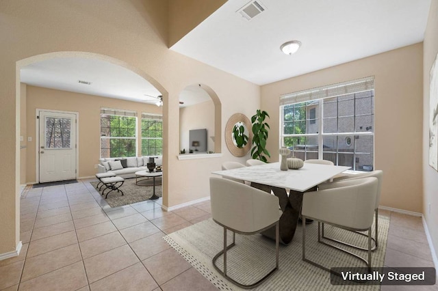 13321 Kirkglen Dr, Austin, TX 78727 - dining space featuring arched walkways, baseboards, light tile patterned floors, and a ceiling fan