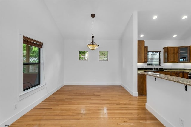 2105 Brackenridge St, Austin, TX 78704 - unfurnished dining area with plenty of natural light, recessed lighting, lofted ceiling, and light wood-style flooring