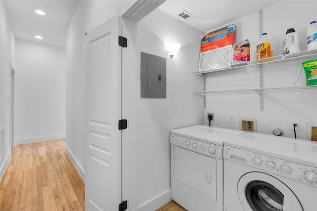 2105 Brackenridge St, Austin, TX 78704 - washroom featuring electric panel, washing machine and dryer, recessed lighting, and light wood-type flooring
