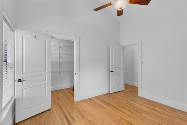 2105 Brackenridge St, Austin, TX 78704 - unfurnished bedroom featuring a spacious closet, a closet, light wood finished floors, ceiling fan, and high vaulted ceiling