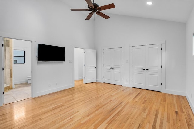 2105 Brackenridge St, Austin, TX 78704 - unfurnished bedroom featuring high vaulted ceiling, multiple closets, light wood-style flooring, recessed lighting, and connected bathroom