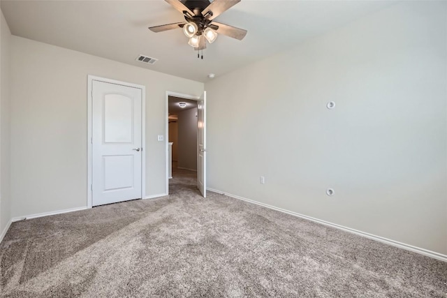 unfurnished bedroom with baseboards, visible vents, carpet, and ceiling fan