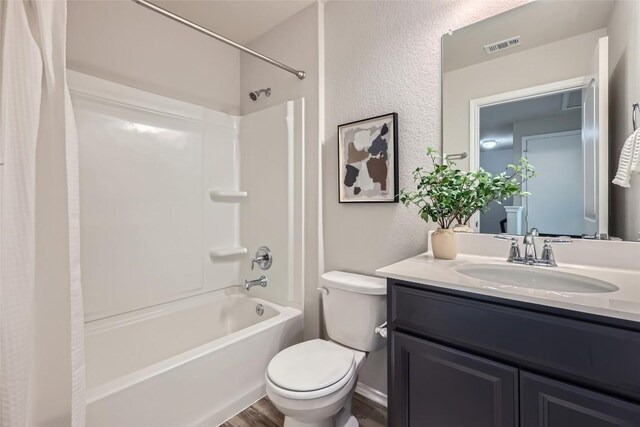 10504 Abana Way, Austin, TX 78748 - full bath featuring shower / bath combination with curtain, vanity, a textured wall, and wood finished floors