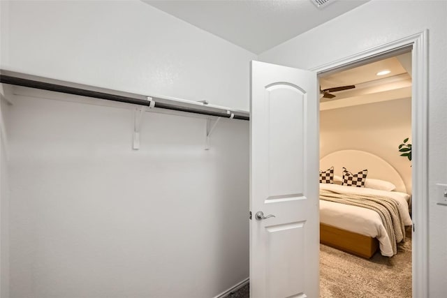 walk in closet featuring light carpet