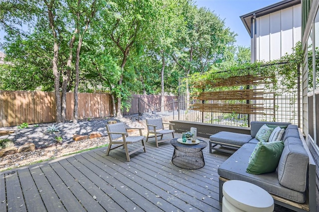 wooden deck featuring an outdoor hangout area and a fenced backyard