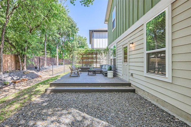view of yard featuring a wooden deck, fence, and outdoor lounge area