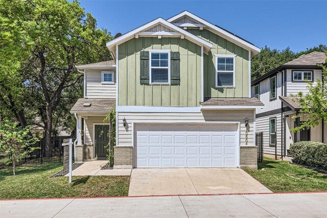 10504 Abana Way, Austin, TX 78748 - view of front of home featuring board and batten siding, concrete driveway, an attached garage, and brick siding