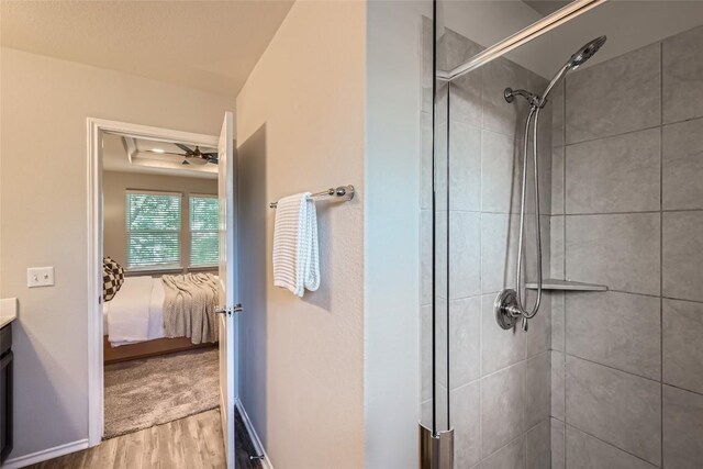 10504 Abana Way, Austin, TX 78748 - ensuite bathroom featuring wood finished floors, a stall shower, and vanity