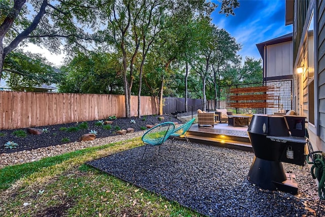 view of yard featuring an outdoor living space, a wooden deck, and a fenced backyard