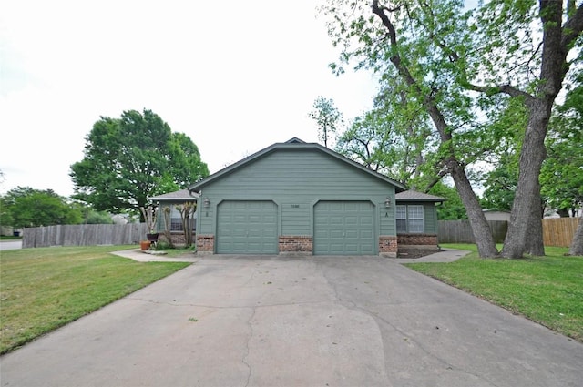 view of side of property with brick siding, a lawn, fence, and driveway