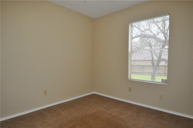 tiled empty room with baseboards