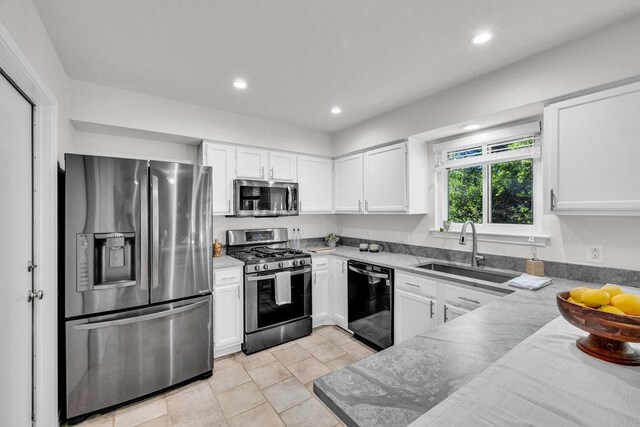 6906 Tesoro Trl, Austin, TX 78729 - kitchen featuring stainless steel appliances, white cabinets, and recessed lighting