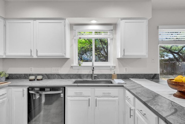 6906 Tesoro Trl, Austin, TX 78729 - kitchen with stainless steel dishwasher, a sink, and white cabinetry