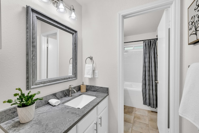 6906 Tesoro Trl, Austin, TX 78729 - full bathroom with vanity, stone finish flooring, and shower / bathtub combination with curtain