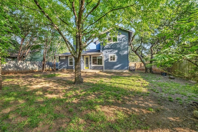 back of house featuring a fenced backyard