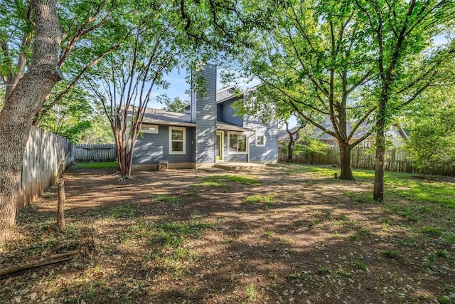 6906 Tesoro Trl, Austin, TX 78729 - back of house featuring a fenced backyard and a chimney