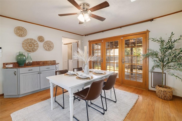 dining area featuring french doors, crown molding, baseboards, light wood-style flooring, and ceiling fan